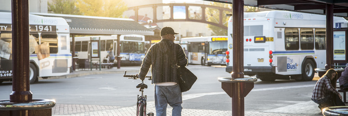 bicyclist at bus station