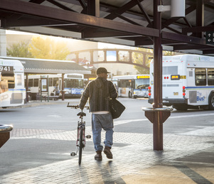 bicyclist at bus station