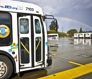 bus in parking lot with rainbow