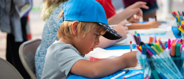 Child uses markers to create a craft project at LTD's station