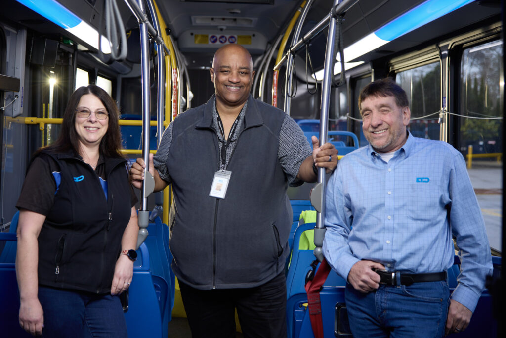 employees standing inside a bus