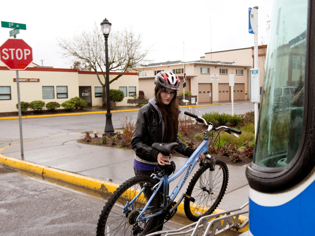 bike being placed on a bus bike rack