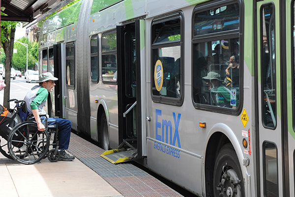 person on wheelchair getting on EmX
