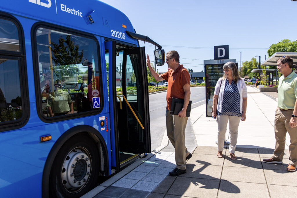 people waiting to get on a bus