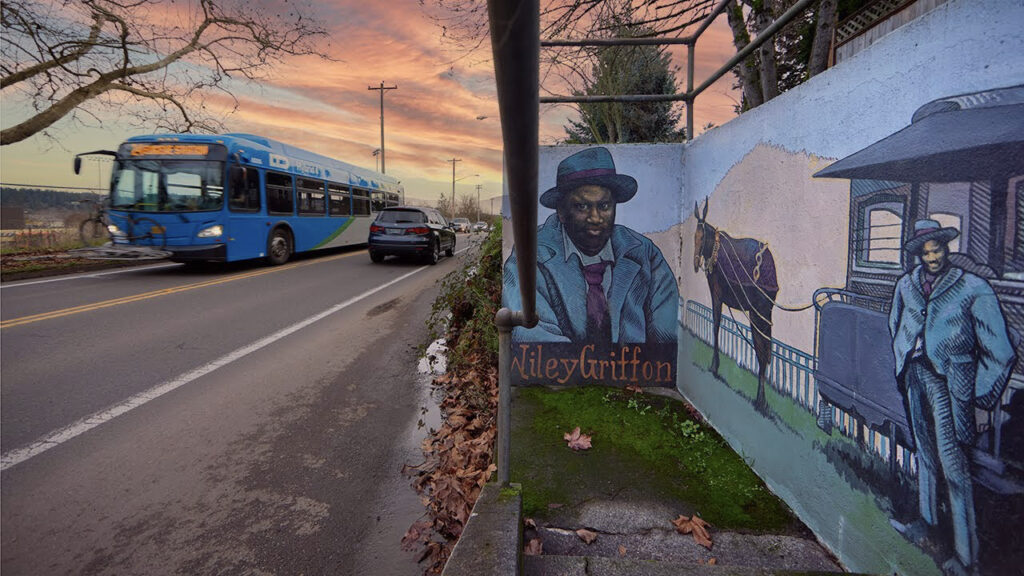 bus driving along a road at sunset