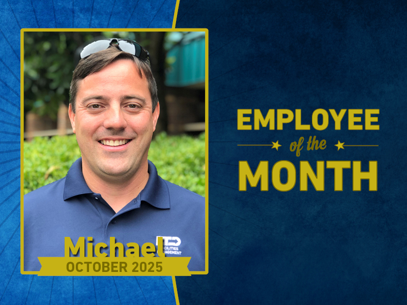 A man in a blue polo shirt smiles for a photo next to text that reads 