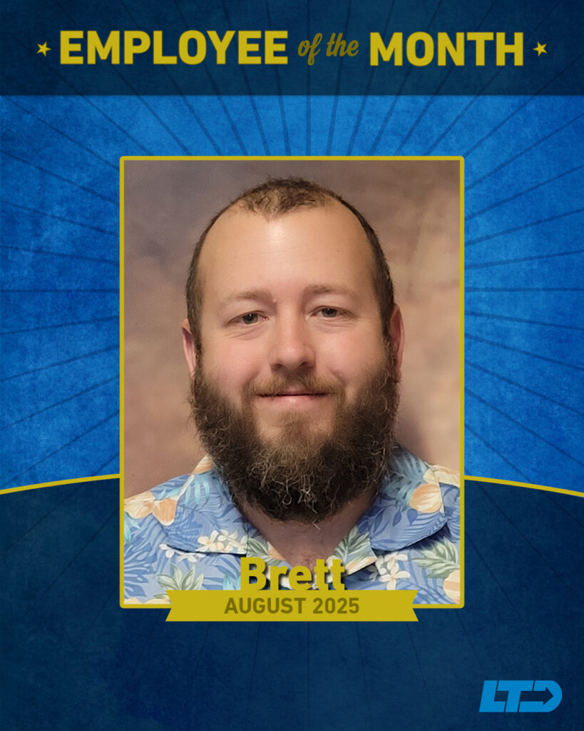 Portrait of a bearded man in a floral shirt, labeled "Employee of the Month&mdash;Brett, August 2025" with a blue and gold decorative background.