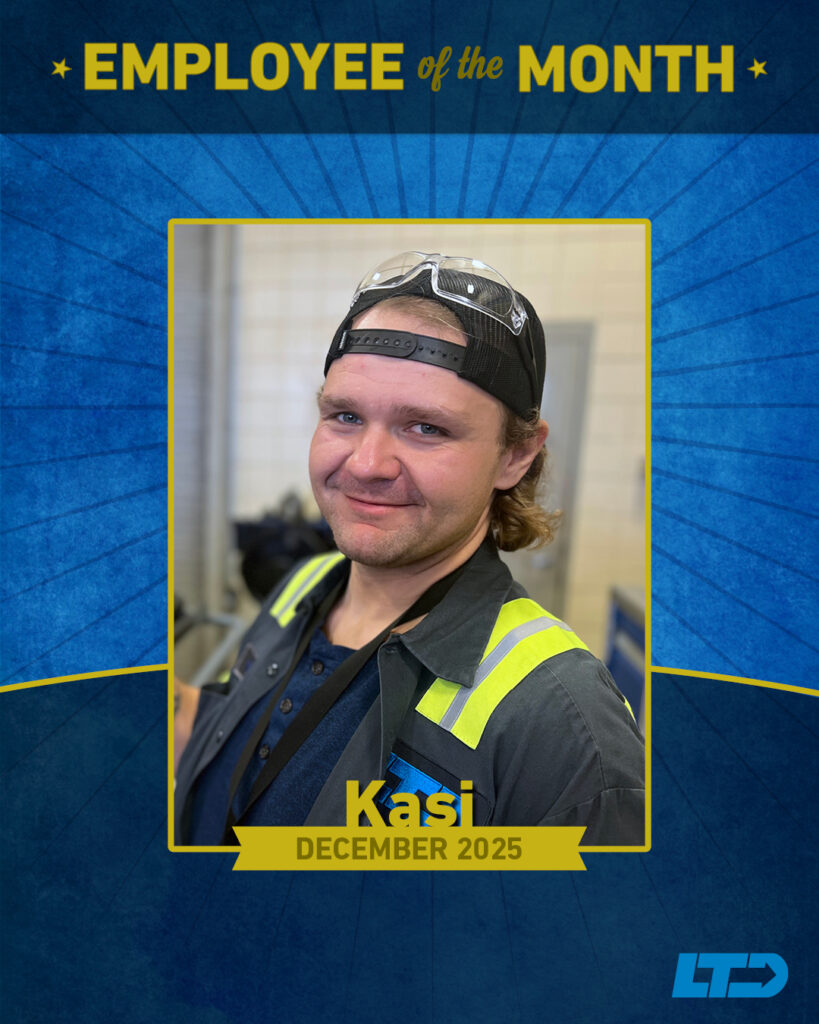 A man wearing safety glasses and a work uniform is featured as Employee of the Month for December 2025, with the name "Kasi" displayed on a banner.