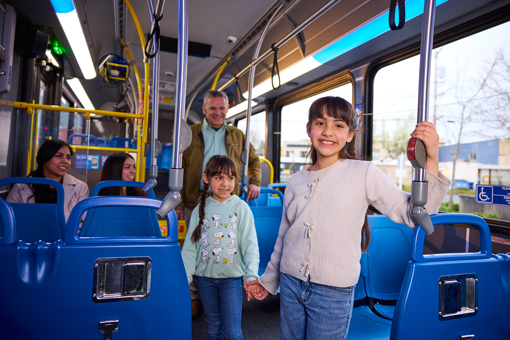 Two young, smiling students riding the LTD Bus.